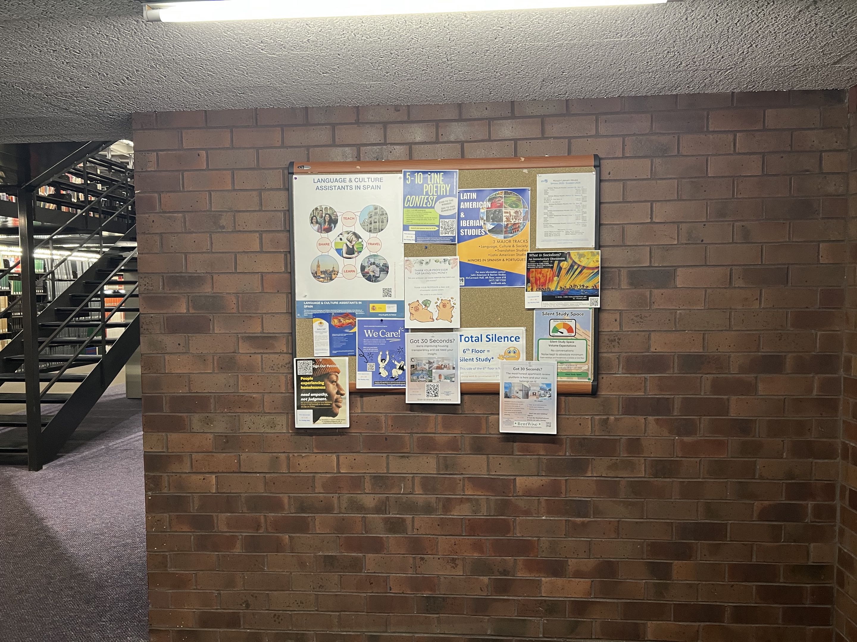 A RentWise flyer posted on a library bulletin board